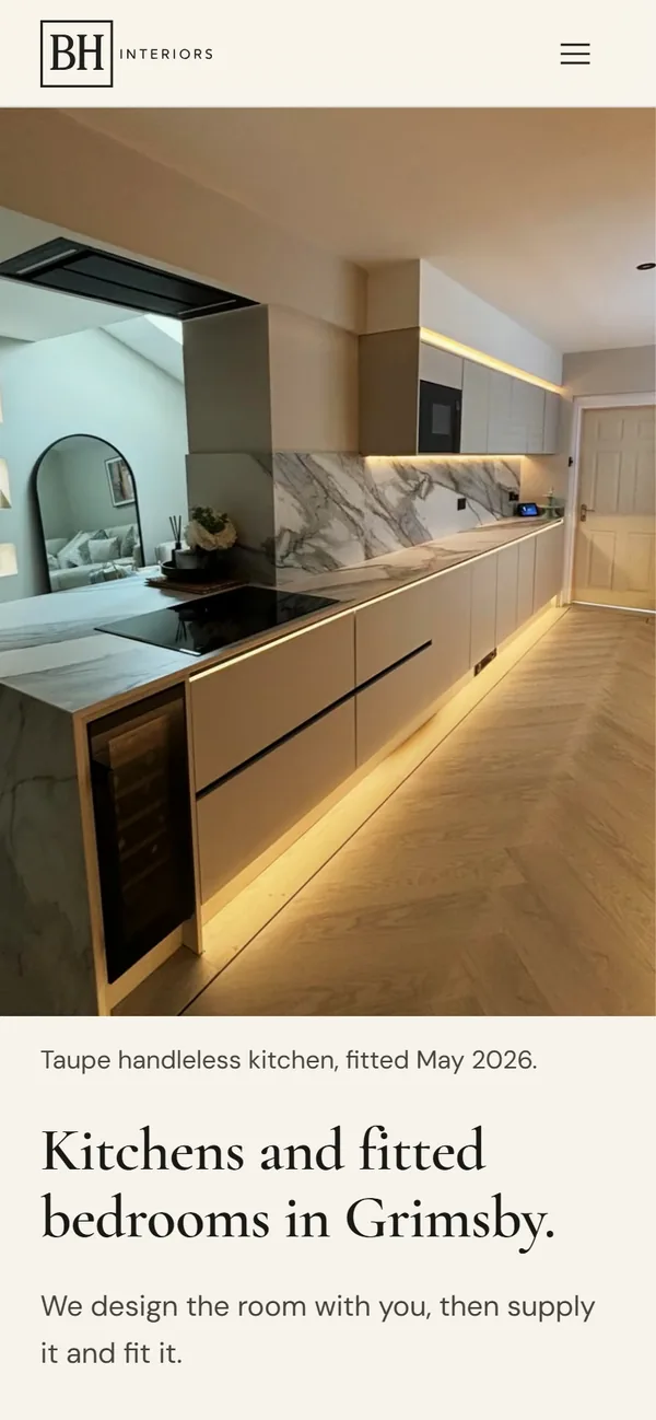 The BH Interiors website on a phone, opening on a full-screen photograph of a taupe kitchen under the headline Kitchens and fitted bedrooms in Grimsby